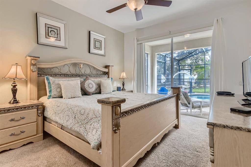 Bedroom with King Sized Bed and Pool View at Memory Lane Villa in Windsor Hills Vacation Rental Community Florida